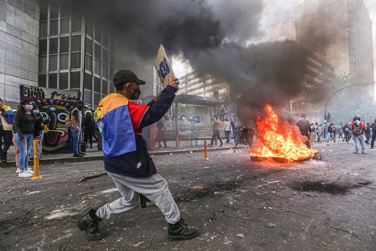 Protesters burn tyres to create a bonfire.