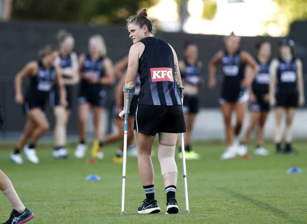 Collingwood Magpies AFLW player Brianna Davey on crutches after injuring her ACL.