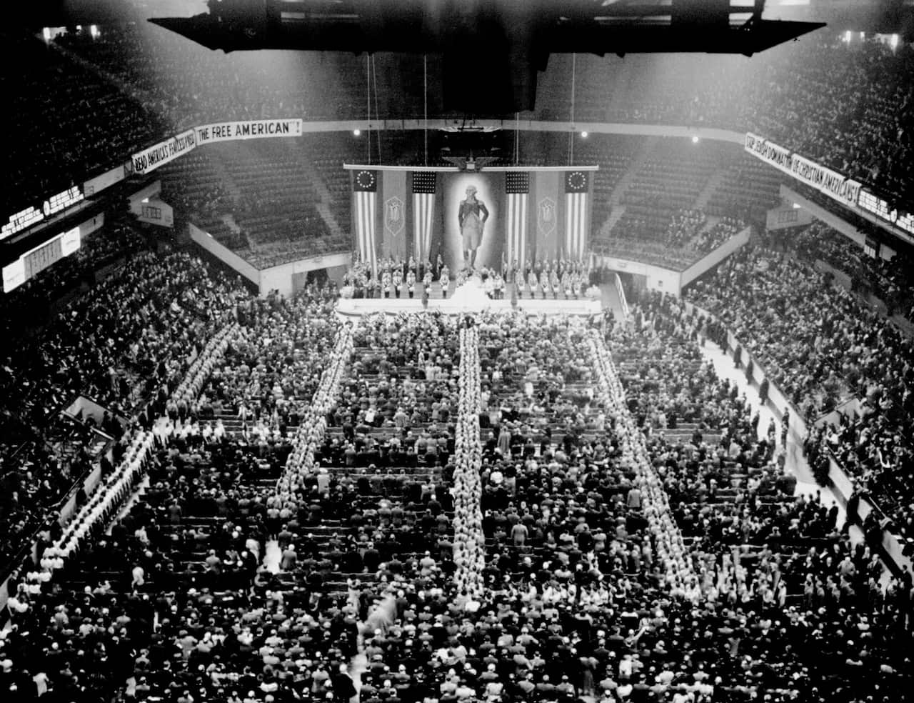 A black-and-white photo of people in a stadium.