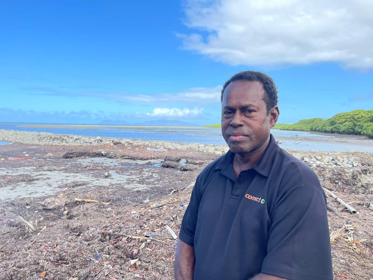 Man sitting with ocean in background.