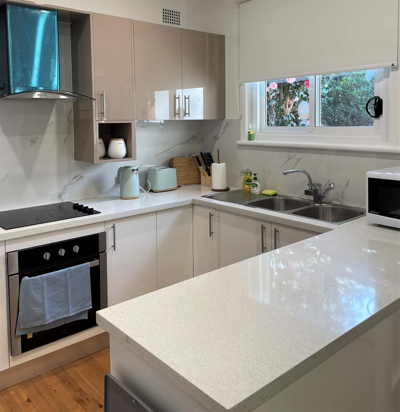 A kitchen with new benches and appliances.