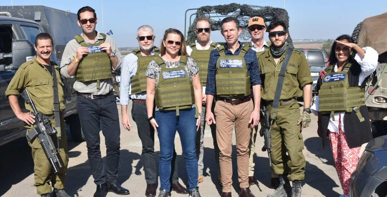 A group of people in bulletproof vests posing for a photo.