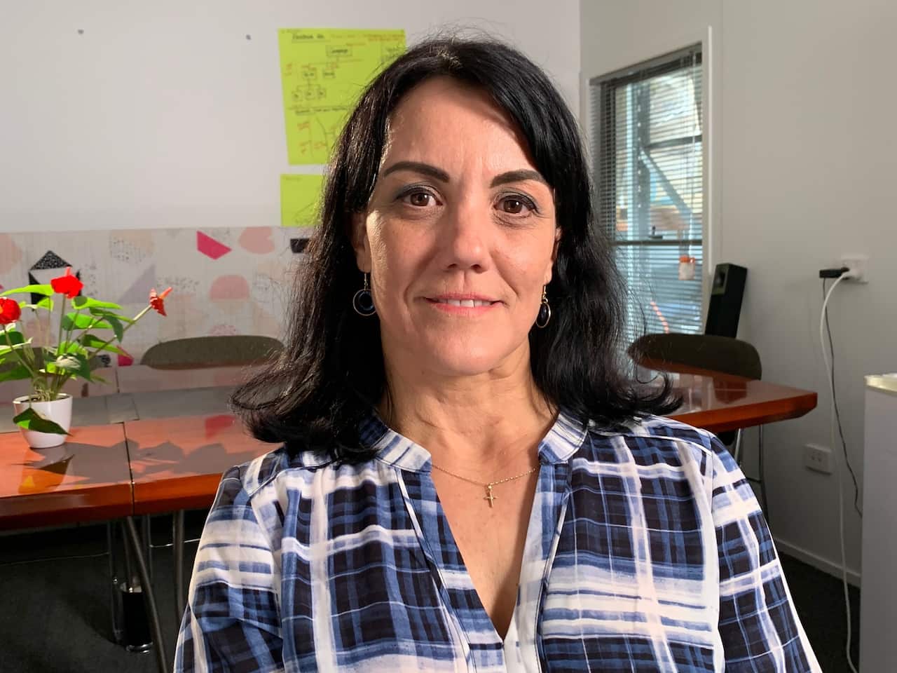 Manuela Whitford sitting in the office at Friends with Dignity in Brisbane