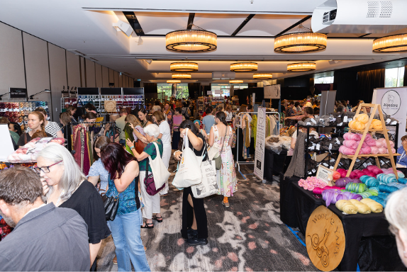 People milling inside a hall during a yarn show.