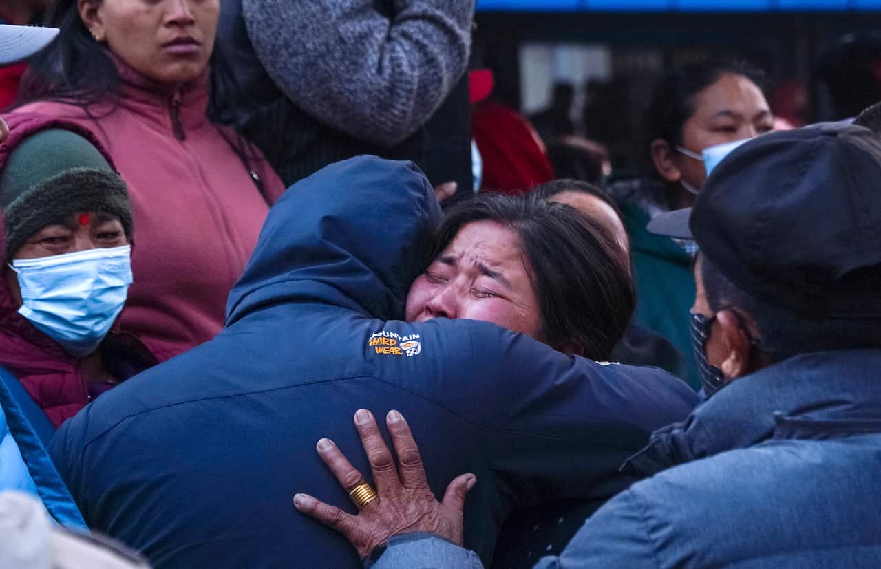 A woman cries as the body of a relative, victim of a plane crash, is brought to a hospital in Pokhara, Nepal.
