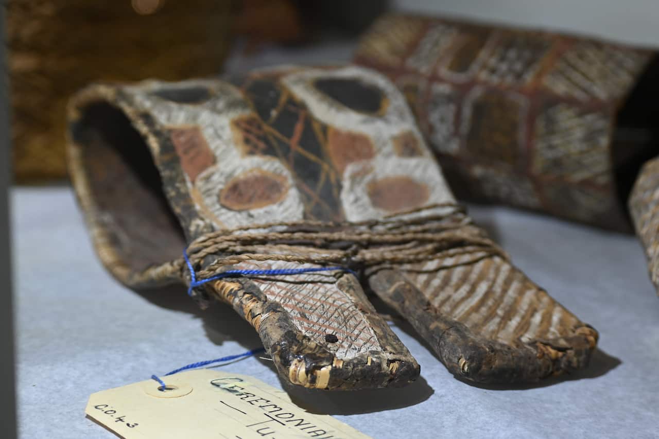 Ceremonial arm bands decorated in white, black, ochre and yellow paint.