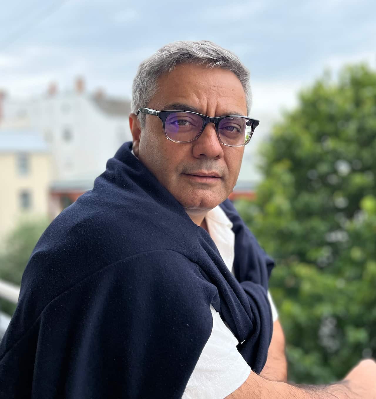 A man wearing glasses looking at the camera.