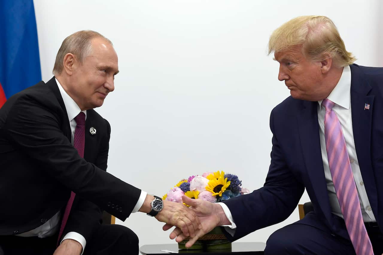 Vladimir Putin and Donald Trump shaking hands.