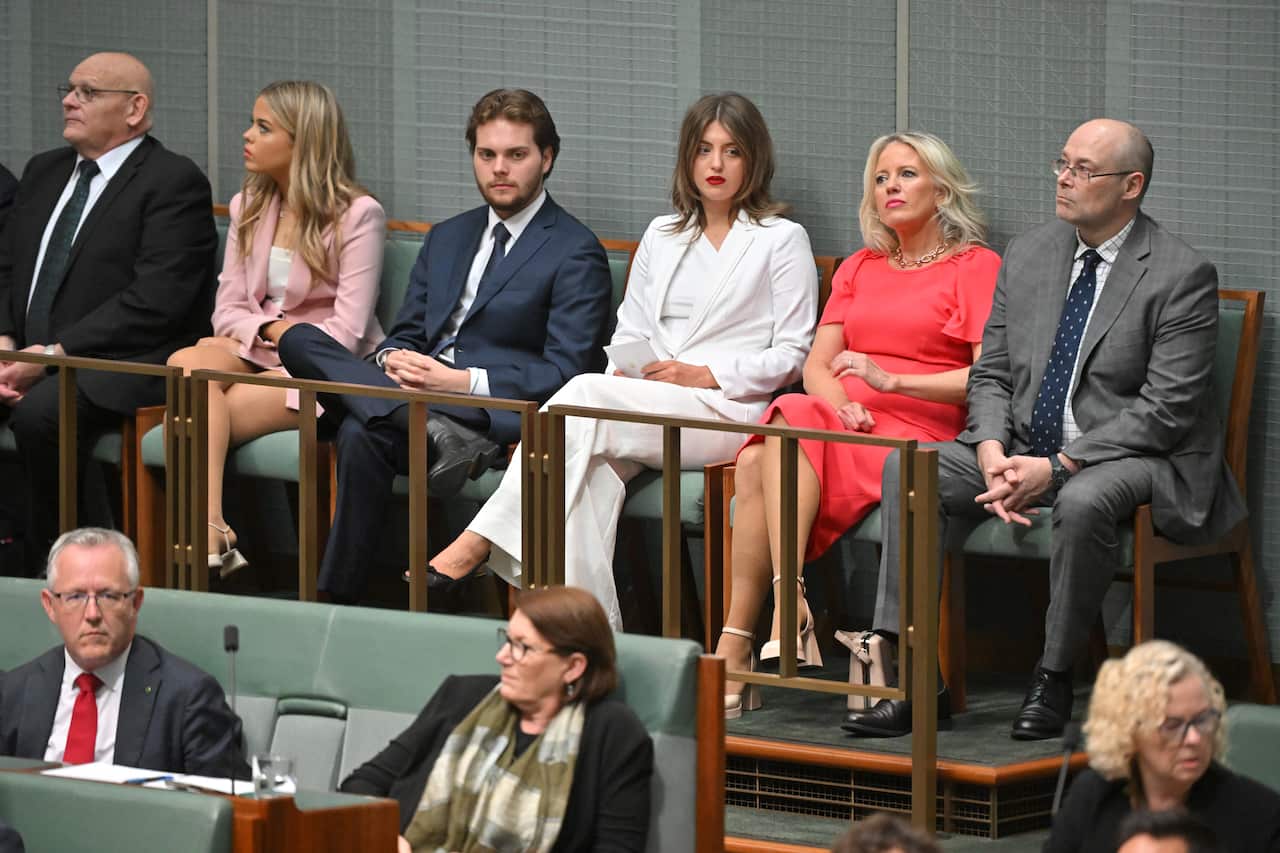 Adults sitting in the Green house of representatives.