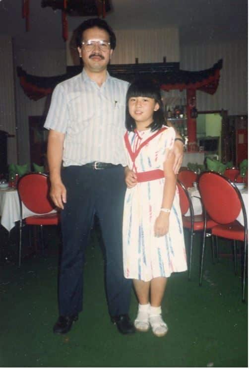 A Chinese man and daughter standing in a Chinese restaurant