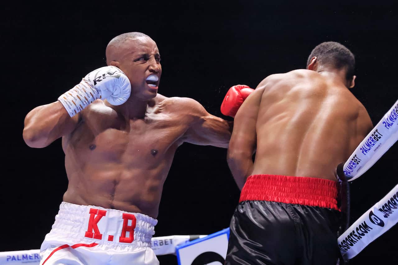 Two men fight in a boxing ring