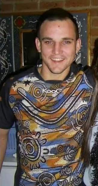 A man wearing an Aboriginal print shirt. 
