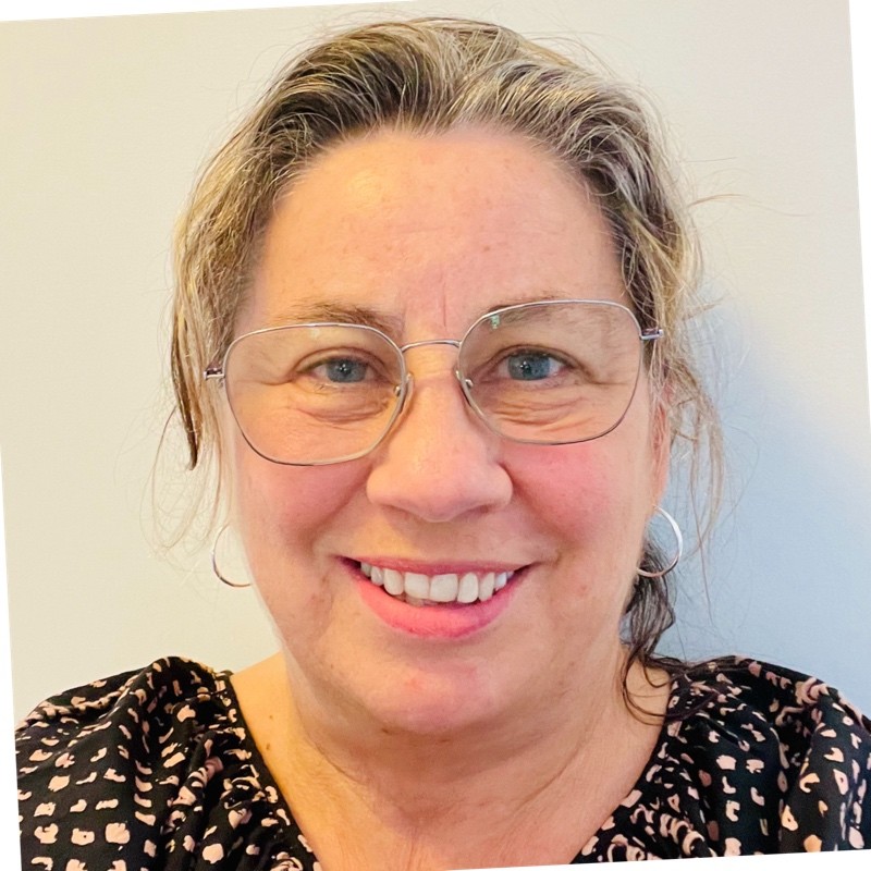 A smiling woman wearing glasses