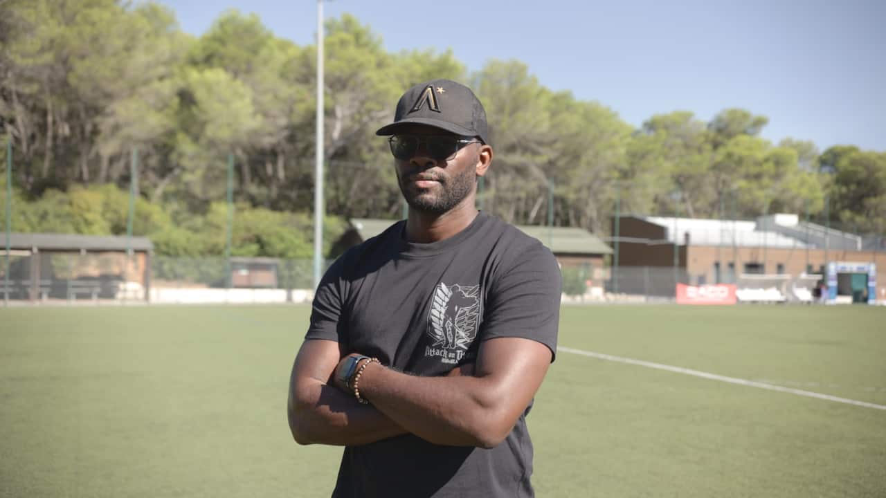 A man wearing a cap and sunglasses.