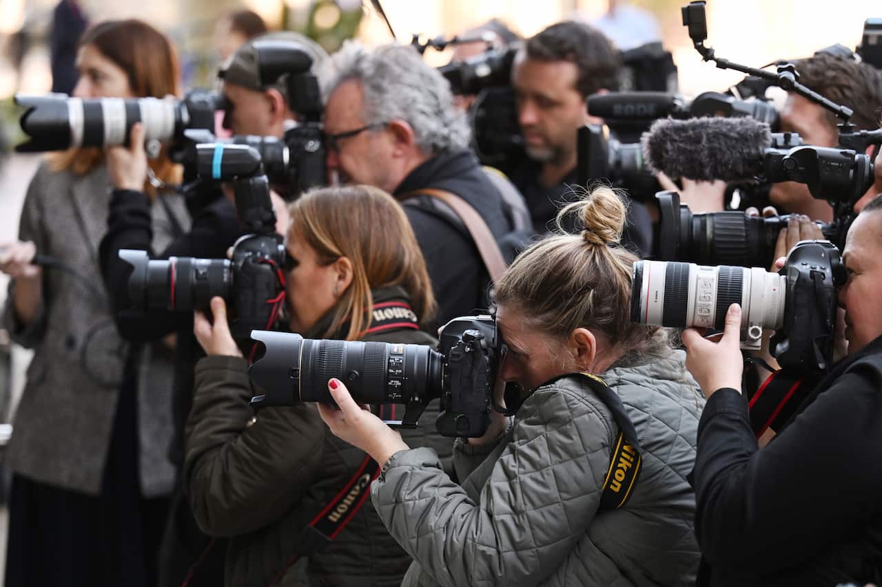 Media photographers are seen outside the NSW Supreme Court.