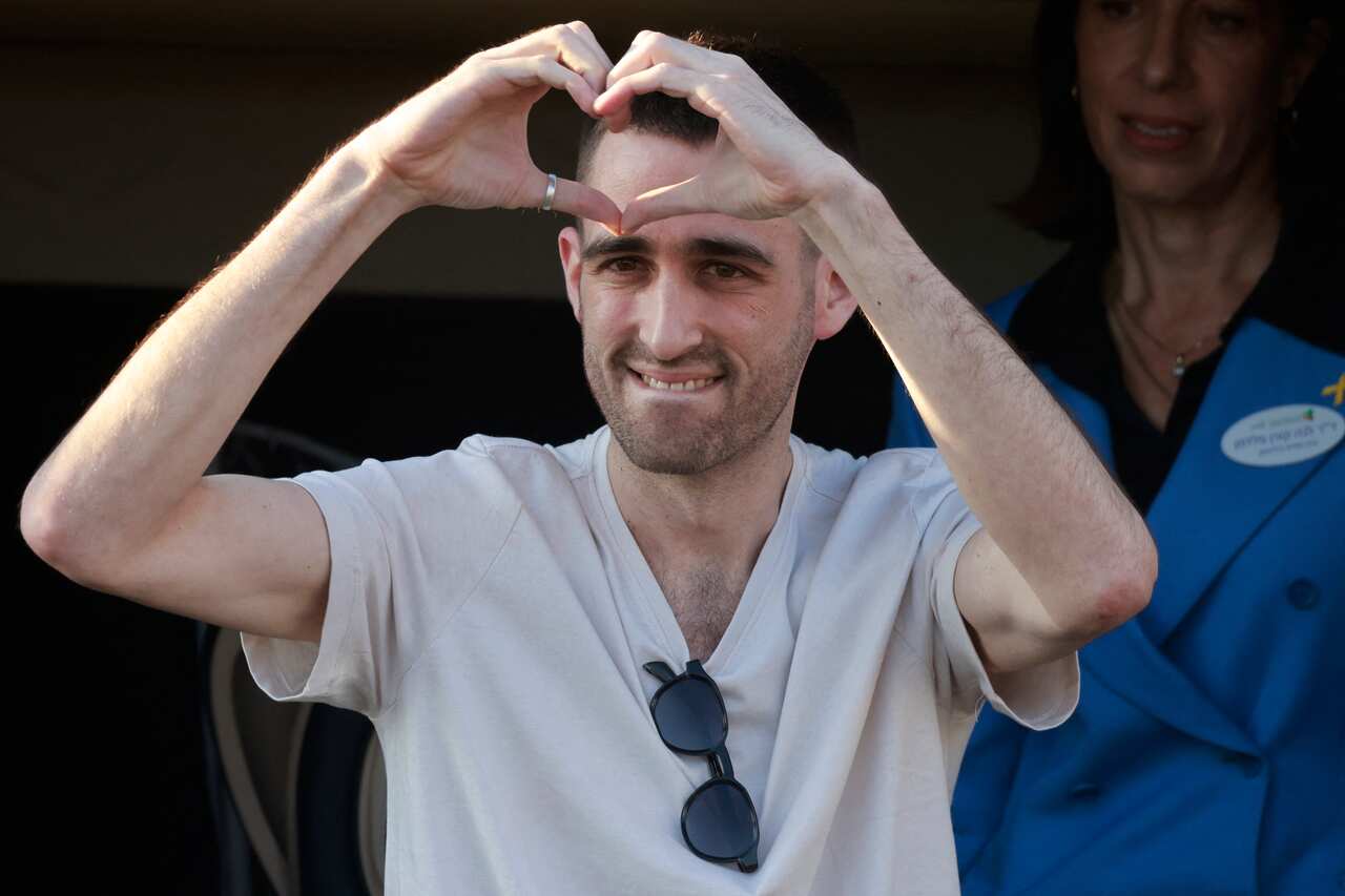 A man making a heart sign with his hands.