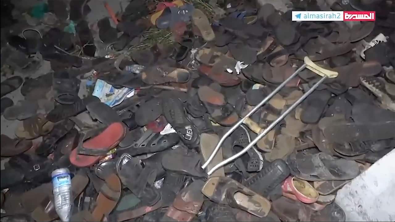 A screenshot showing dozens of pairs of shoes, a water bottle and a walking crutch.