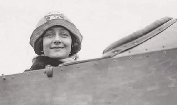 A woman wearing a hat in a plane