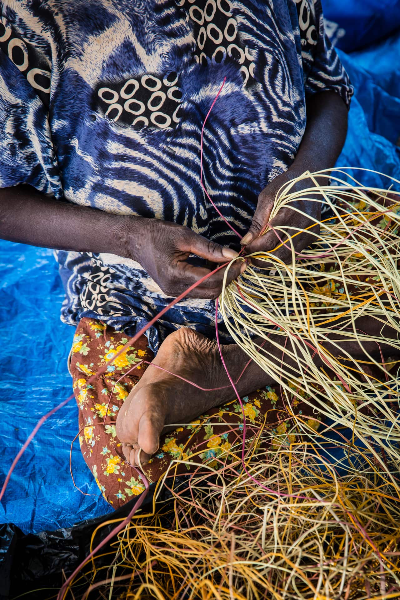 Australia Explained: First Nations weaving - Woman weaving basket with pandanus palm fibre
