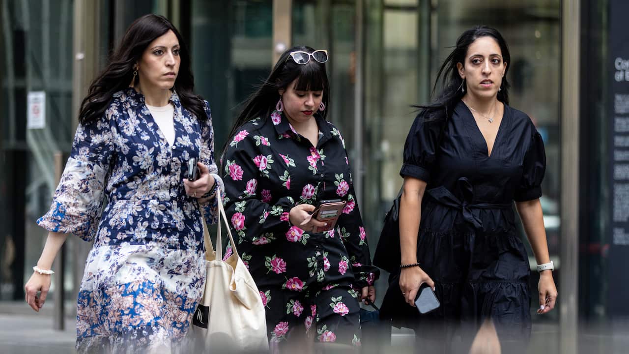 Three women walking away from the Country Court of Victoria.