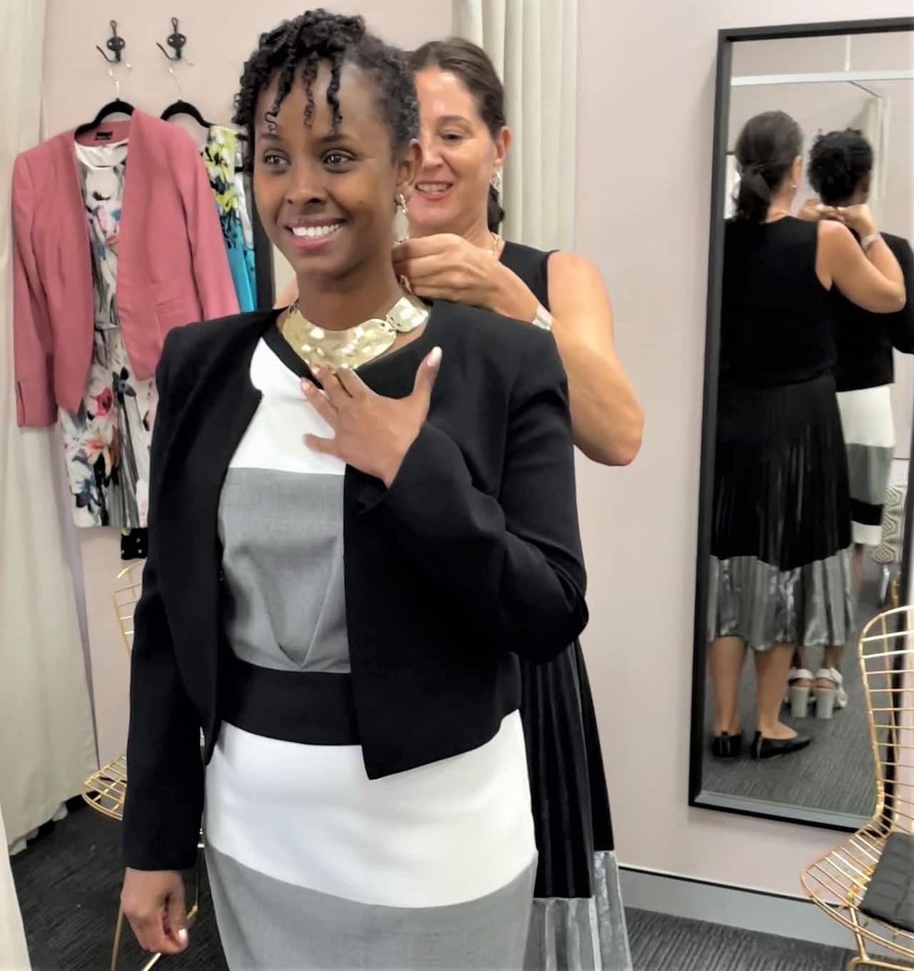 Naima Ibrahim trying on a necklace at Dress for Success.