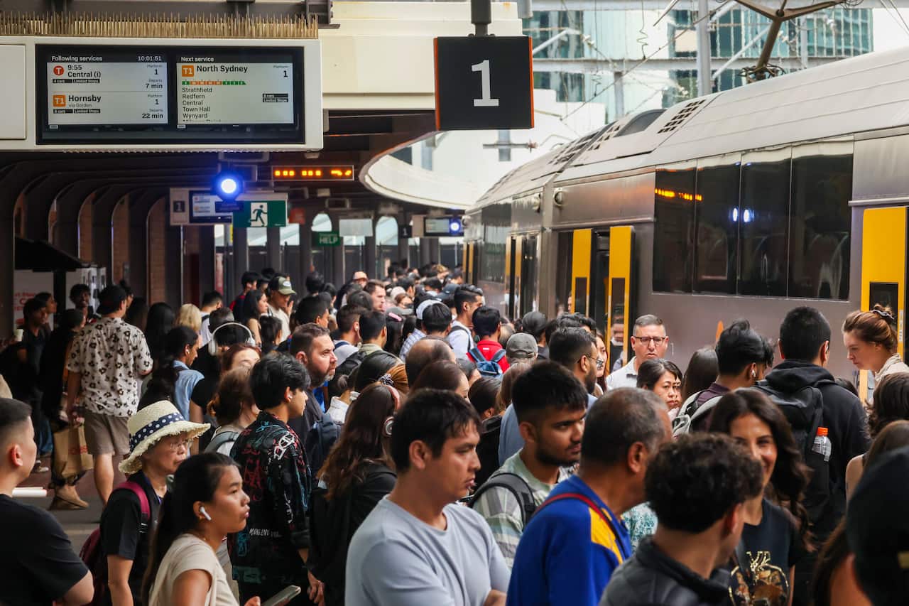 Commuters at a busy train station. 