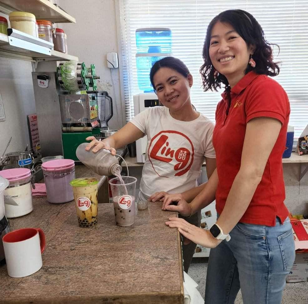 Two women making bubble tea.