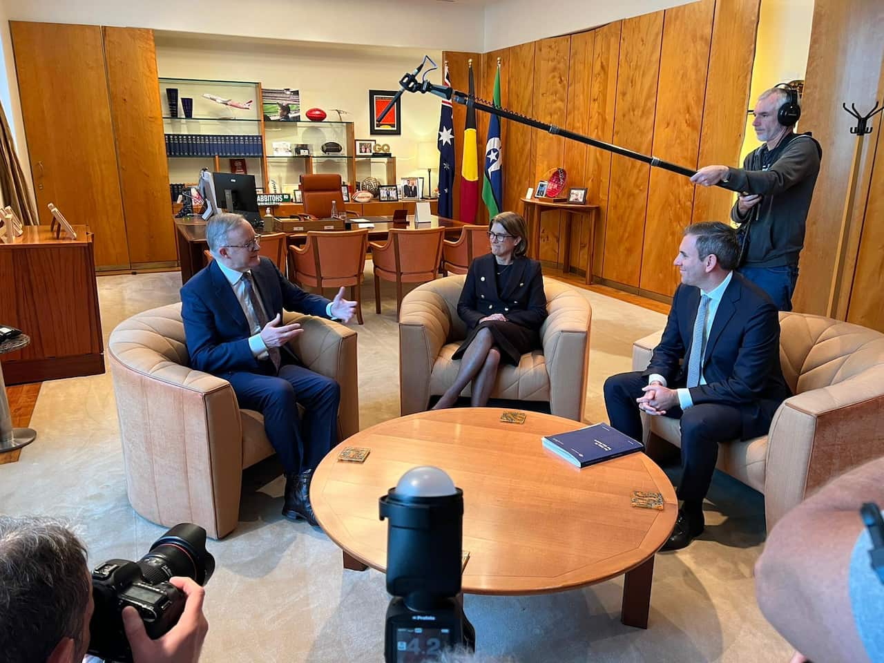 Anthony Albanese, Michele Bullock and Jim Chalmers sitting in chairs talking.