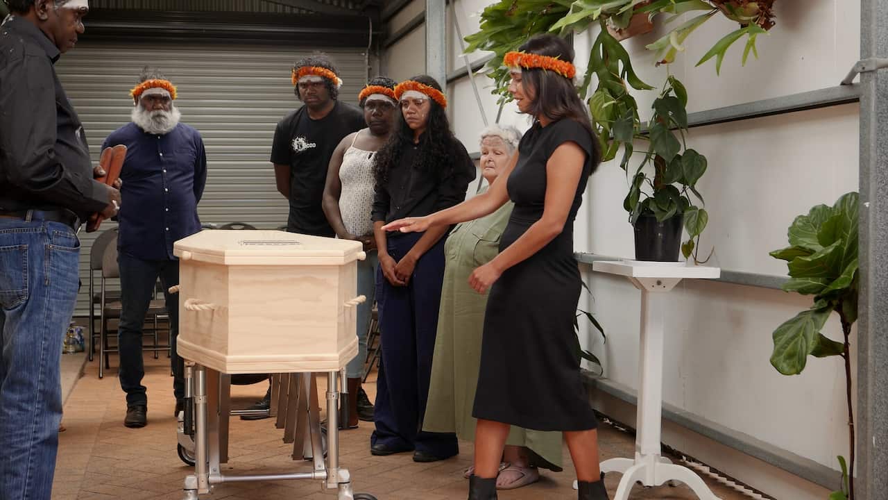 Phoebe (far right) and other members of family and community standing beside David Gulpilil.
