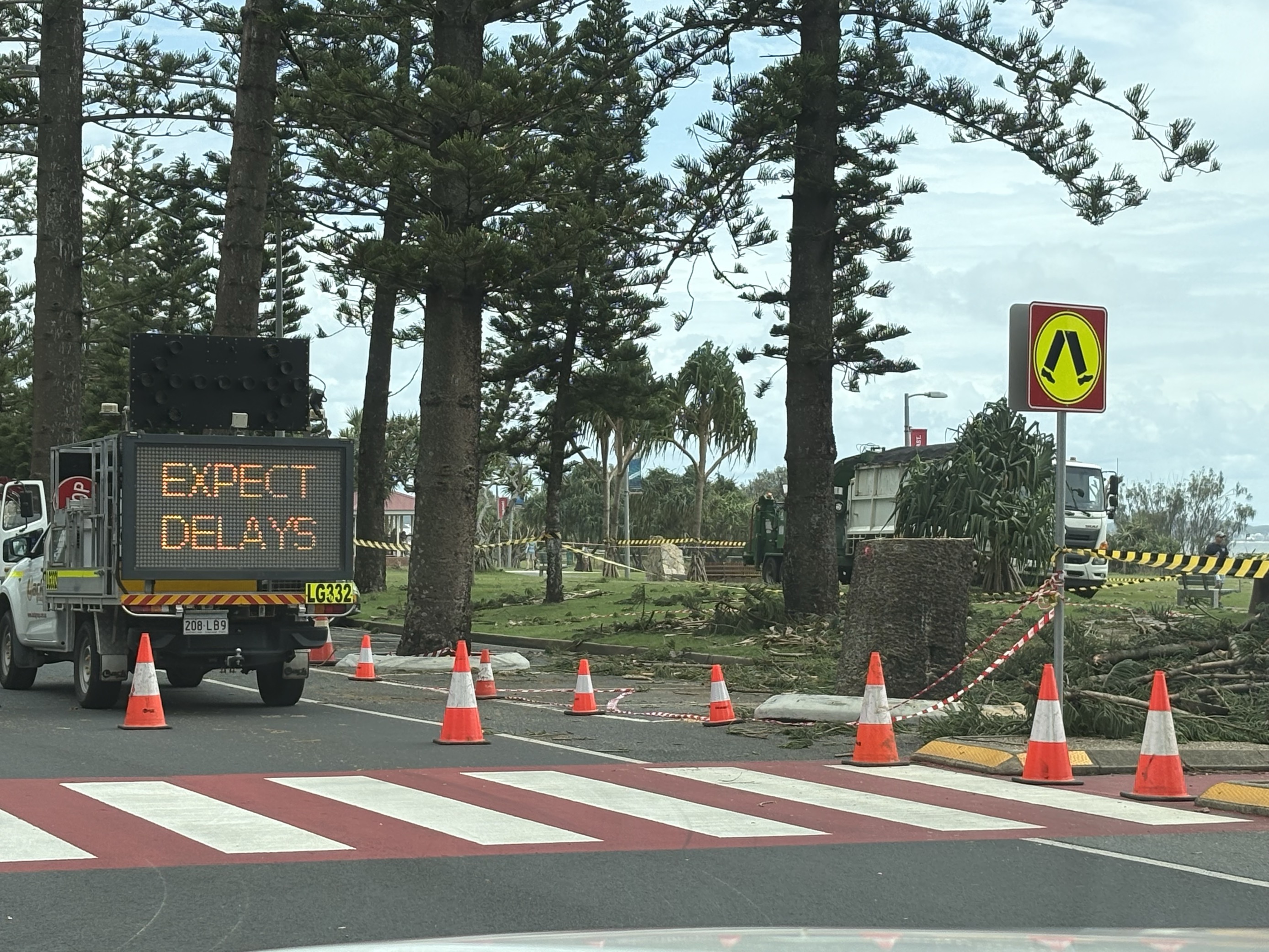 A road is closed as the clean-up from an ex-tropical cyclone begins. 