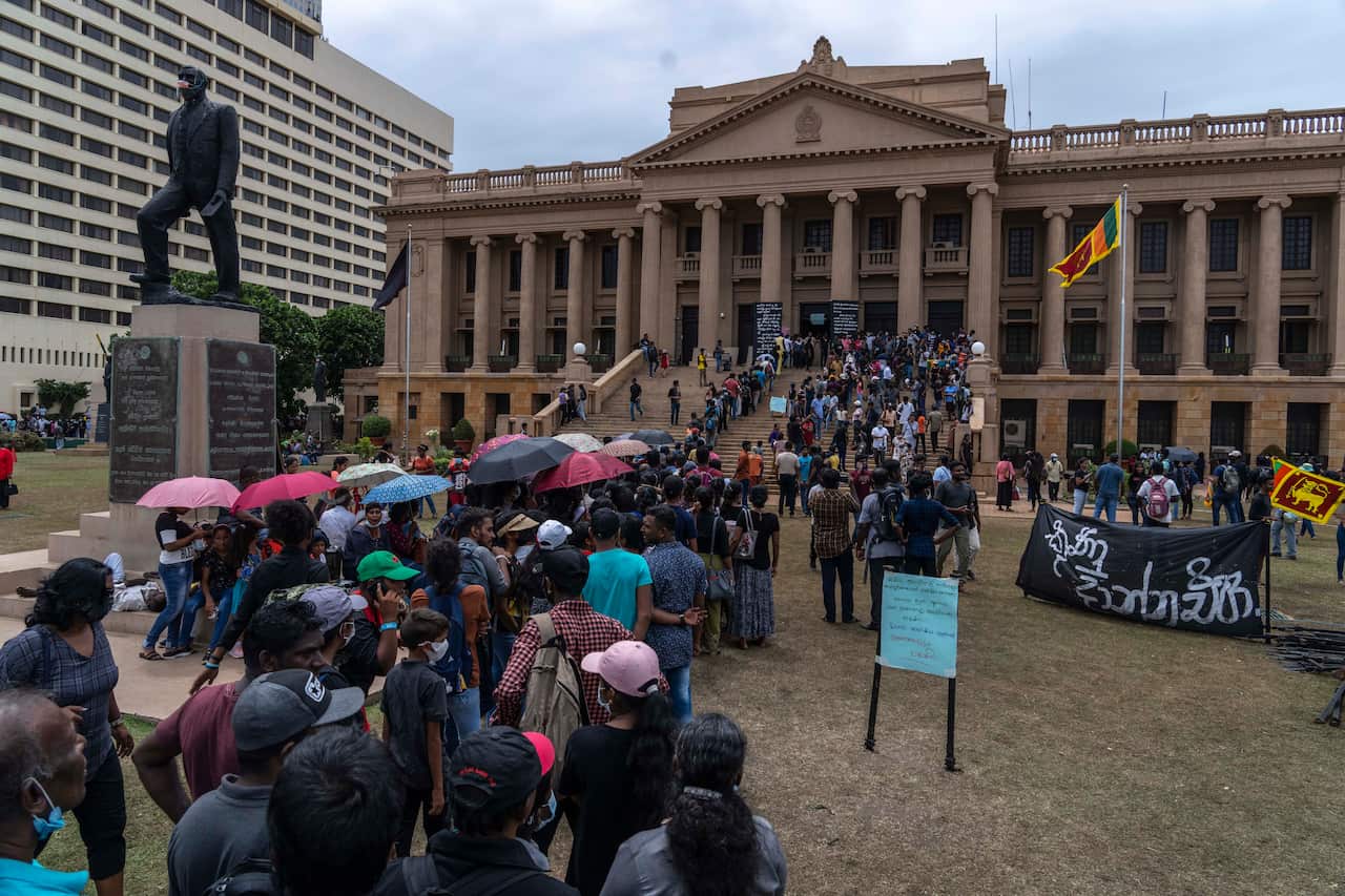 People queue up to visit President Gotabaya Rajapaksa's office for the second day after it was stormed.