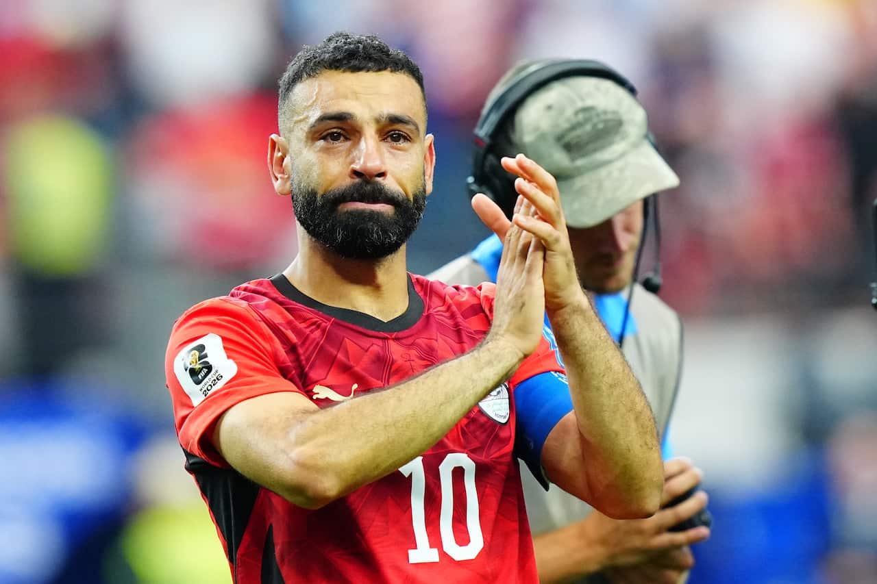Mohamed Salah, an Egyptian man in his 30s dressed in red, weeps and applauds after a win at the 2026 World Cup.