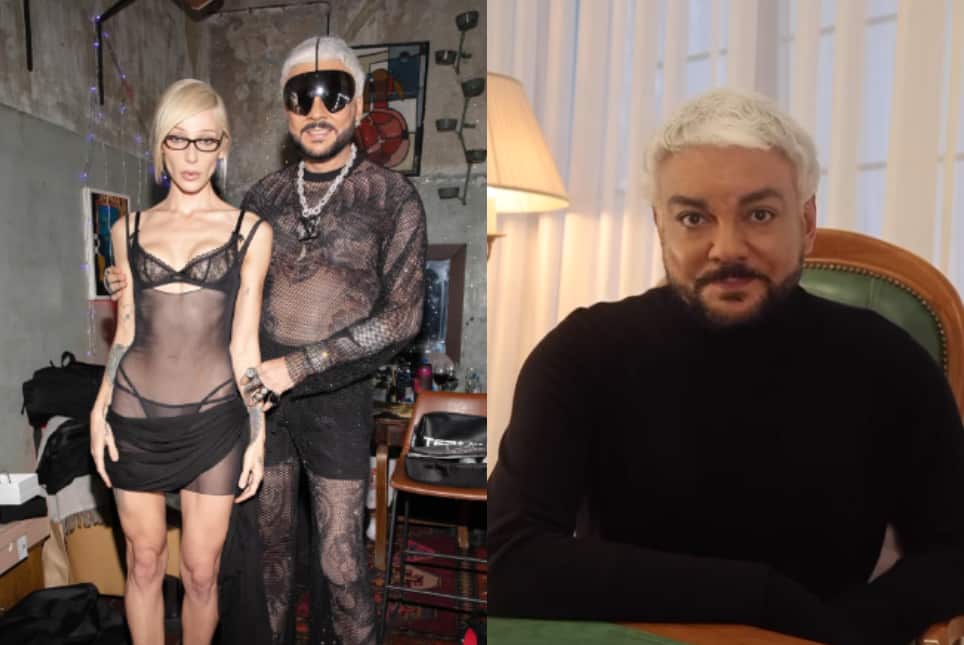 A man and a woman dressed in black are at the party, and the man is wearing a black jumper.