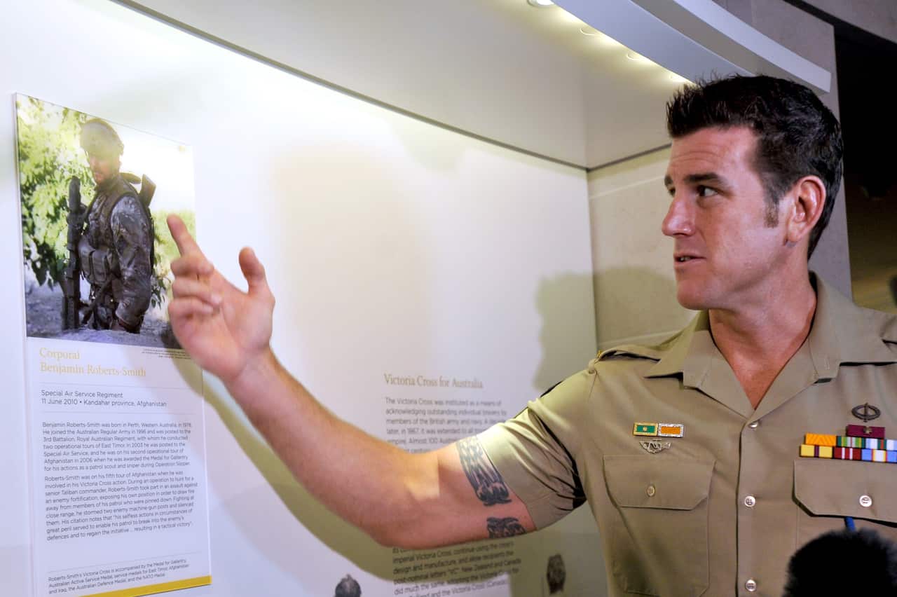 Ben Roberts-Smith observing a display honouring him at the Australian War Memorial.
