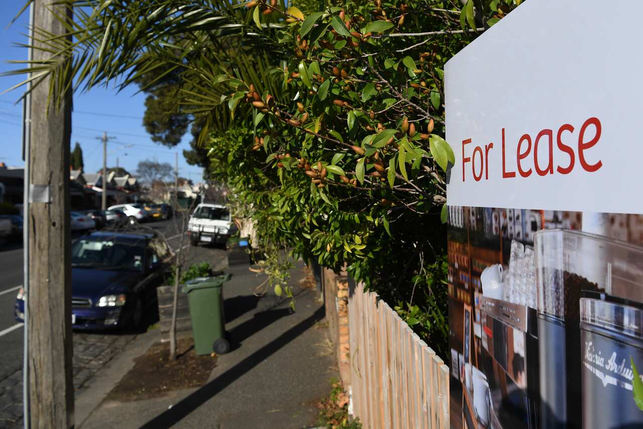 A Melbourne streetscape with a sign at the front of a property that says "For Lease".