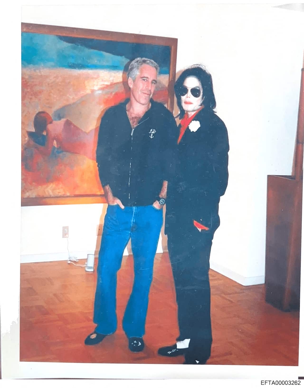Jeffery Epstein stands with his hands in the pockets of his blue jeans next to Michael Jackson