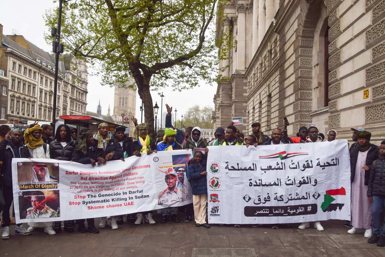 Protesters hold banners during the Sudan demonstration denouncing the UAE's interference in Sudan