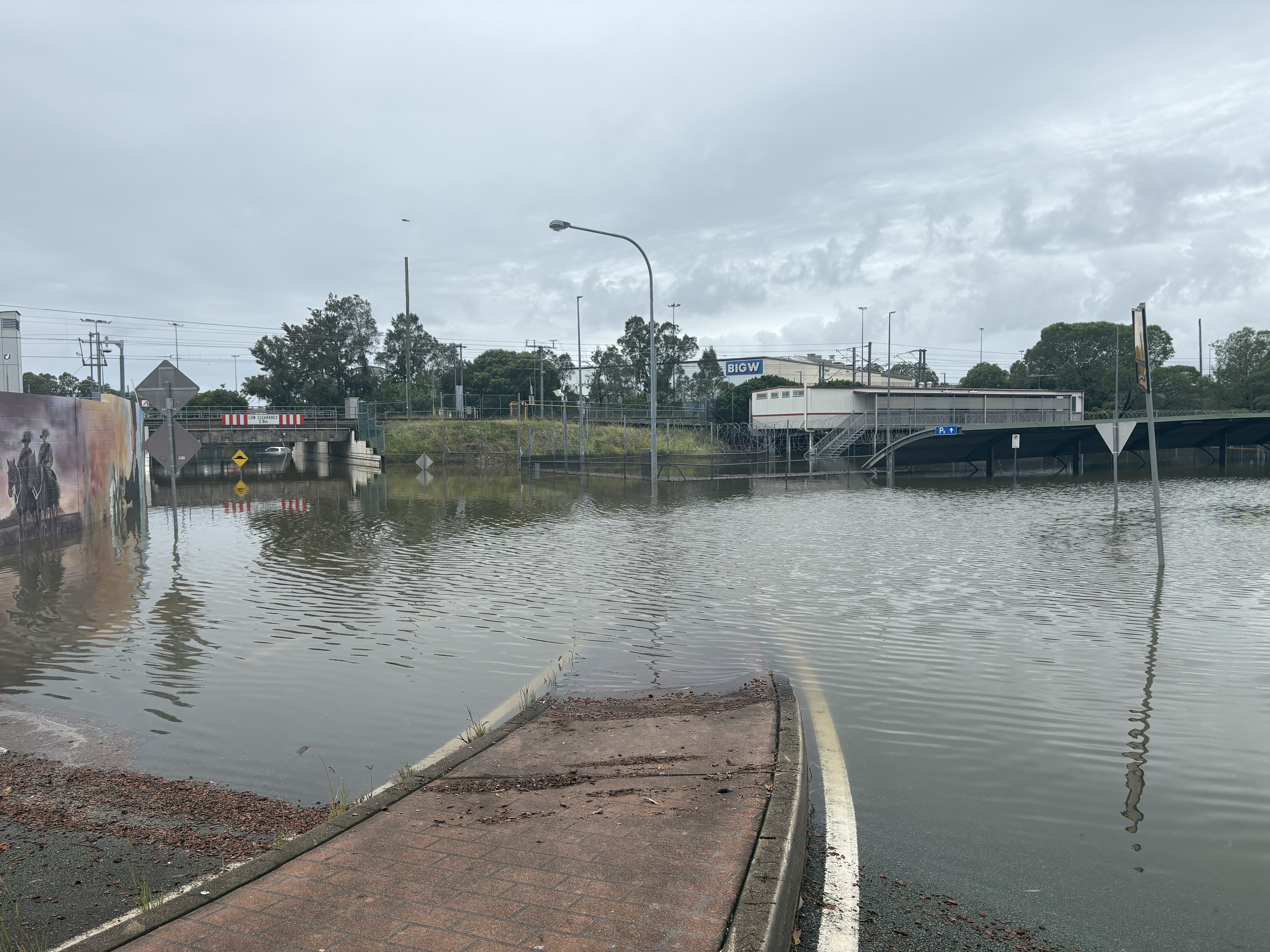 A flooded road with an overcast sky.
