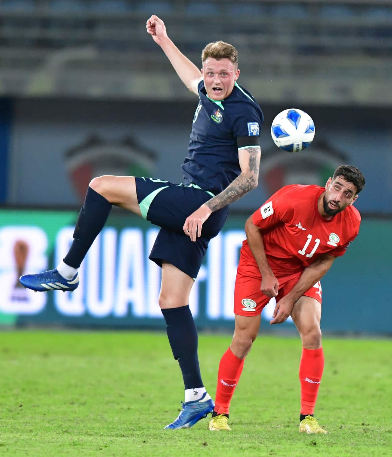 Australia's Harry Souttar, left, and Palestine's Oday Dabbagh battle for the ball