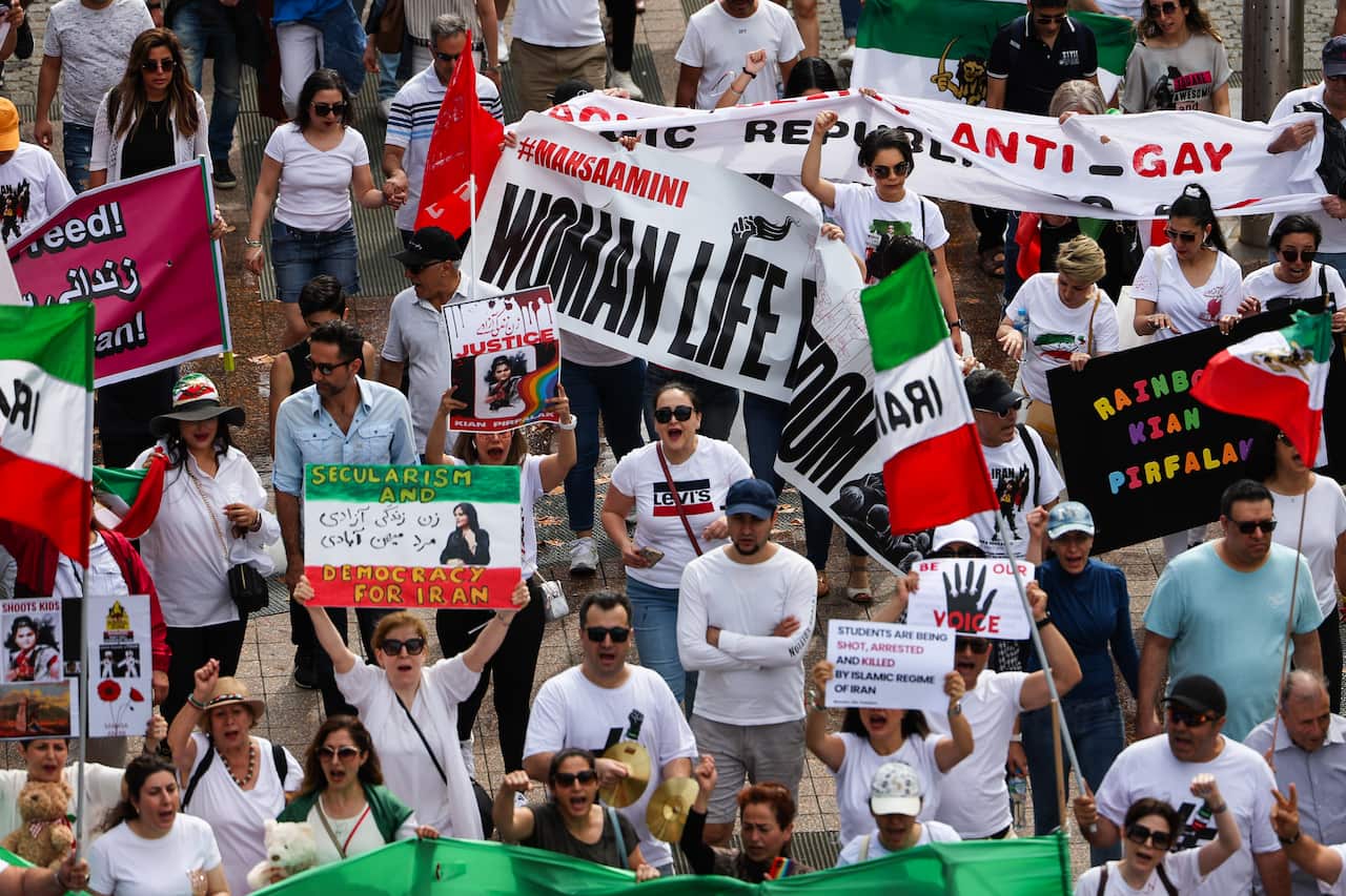 People at a rally holding flags