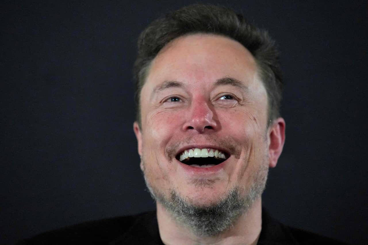 Elon Musk smiling.