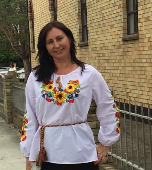 A woman wearing a traditional Ukrainian shirt.