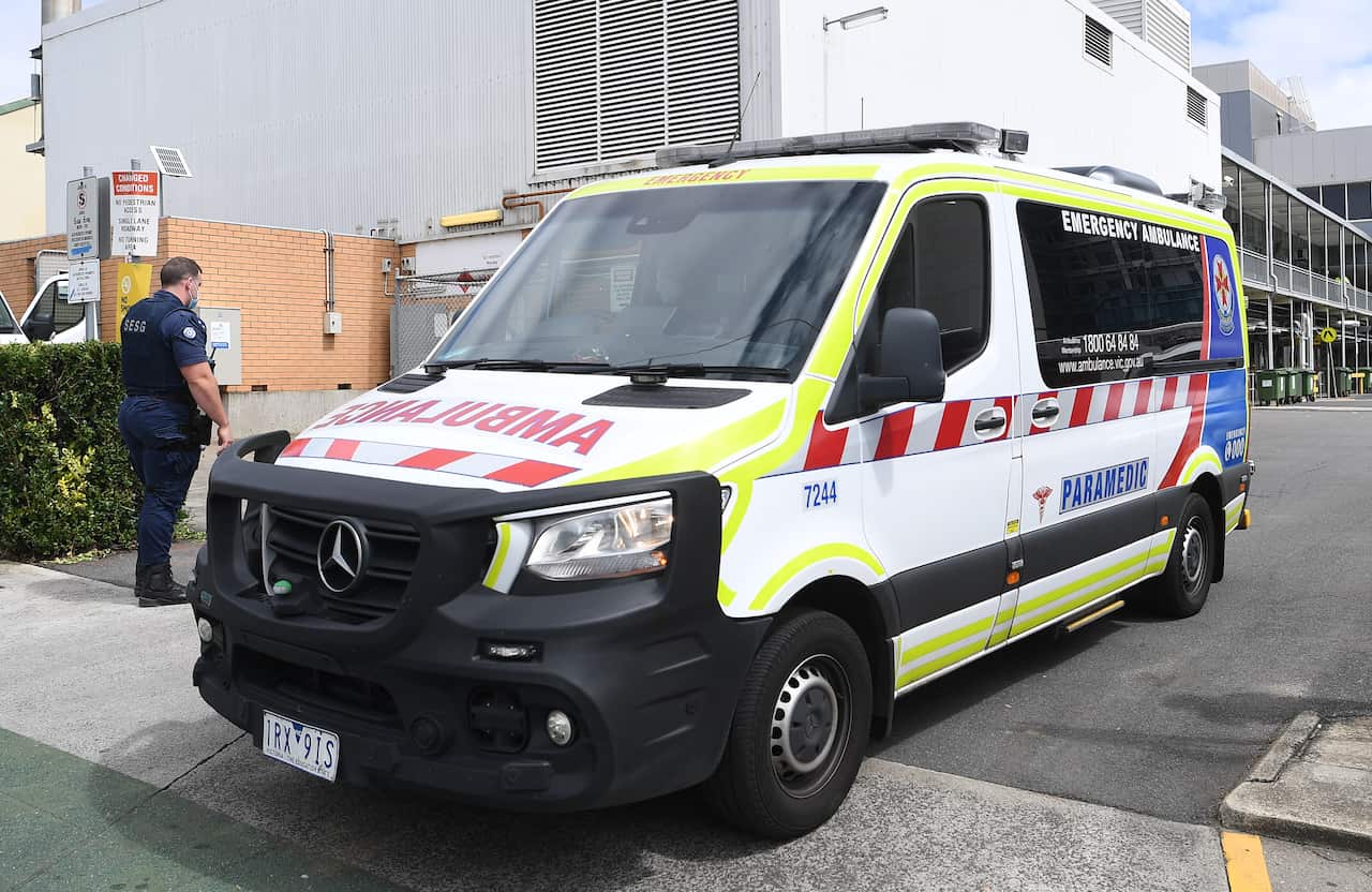 An ambulance vehicle outside a hospital.