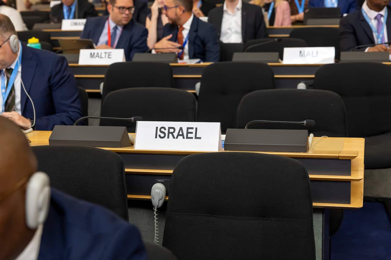 Two empty chairs with a sign in front of it saying "Israel"