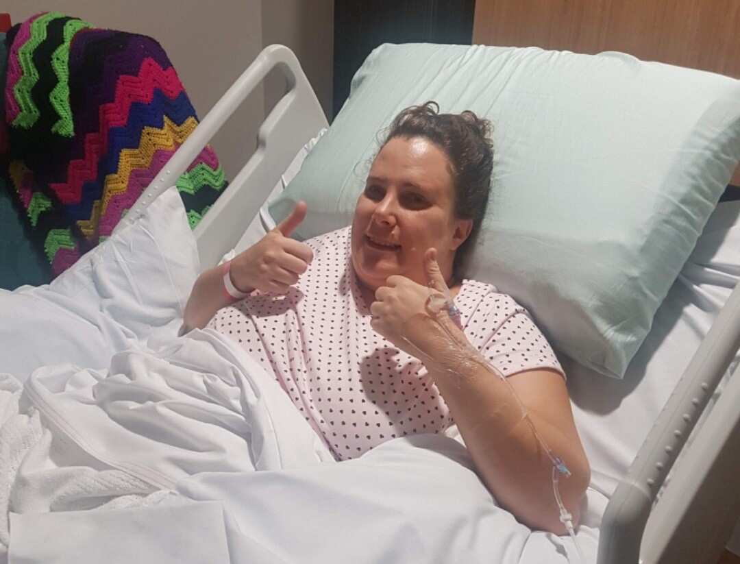 Endometriosis patient Lisa James in a hospital bed after surgery.