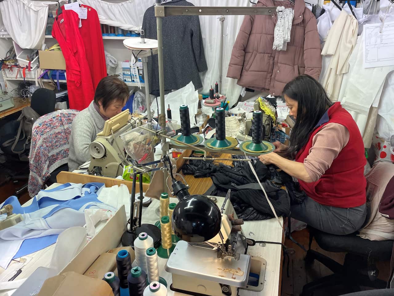 Carla Zampatti staff sitting at sewing machines at head office in Sydney.