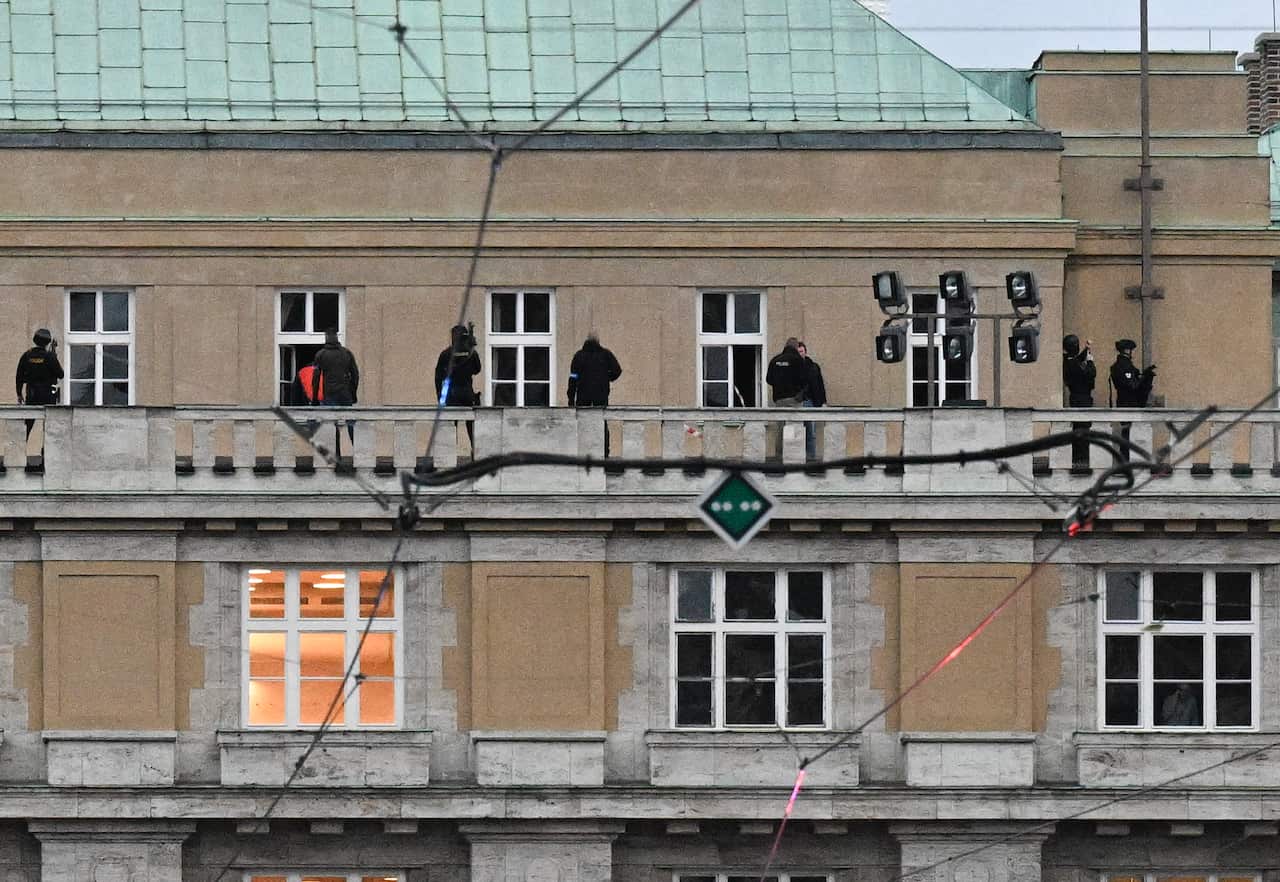 Police on the balcony of a university building.