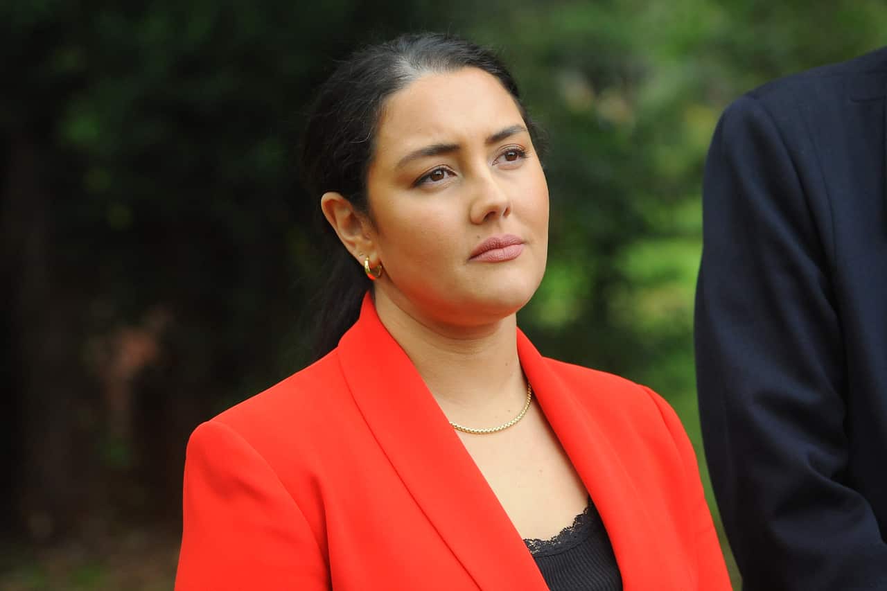A woman in a red blazer.