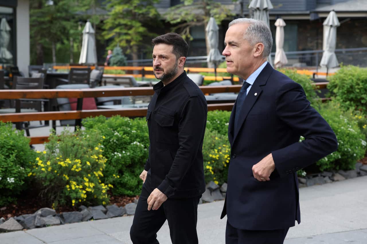 Two men wearing formal attire walking outside.