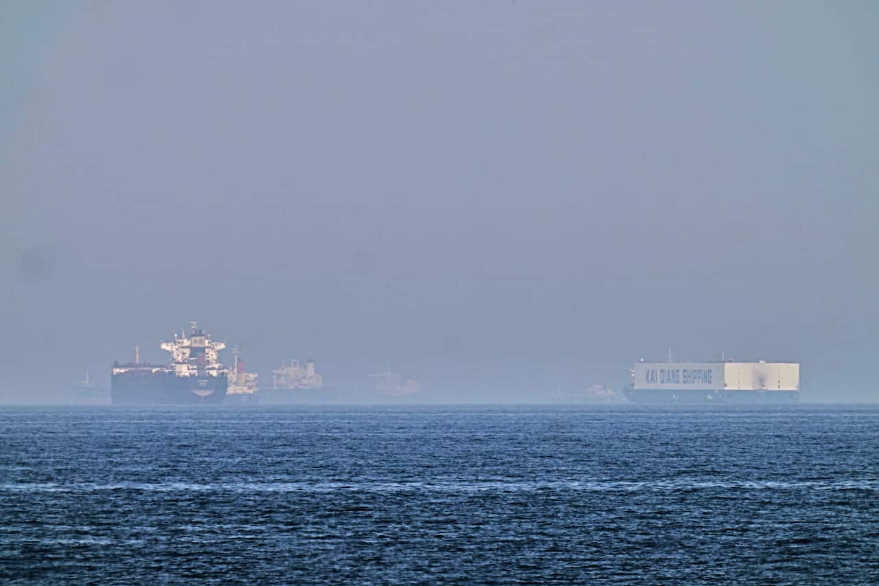 An oil tanker and a ship are seen on the sea